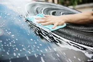 Man cleaning his windshield