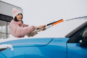 Woman Defrosting her Car Windshield